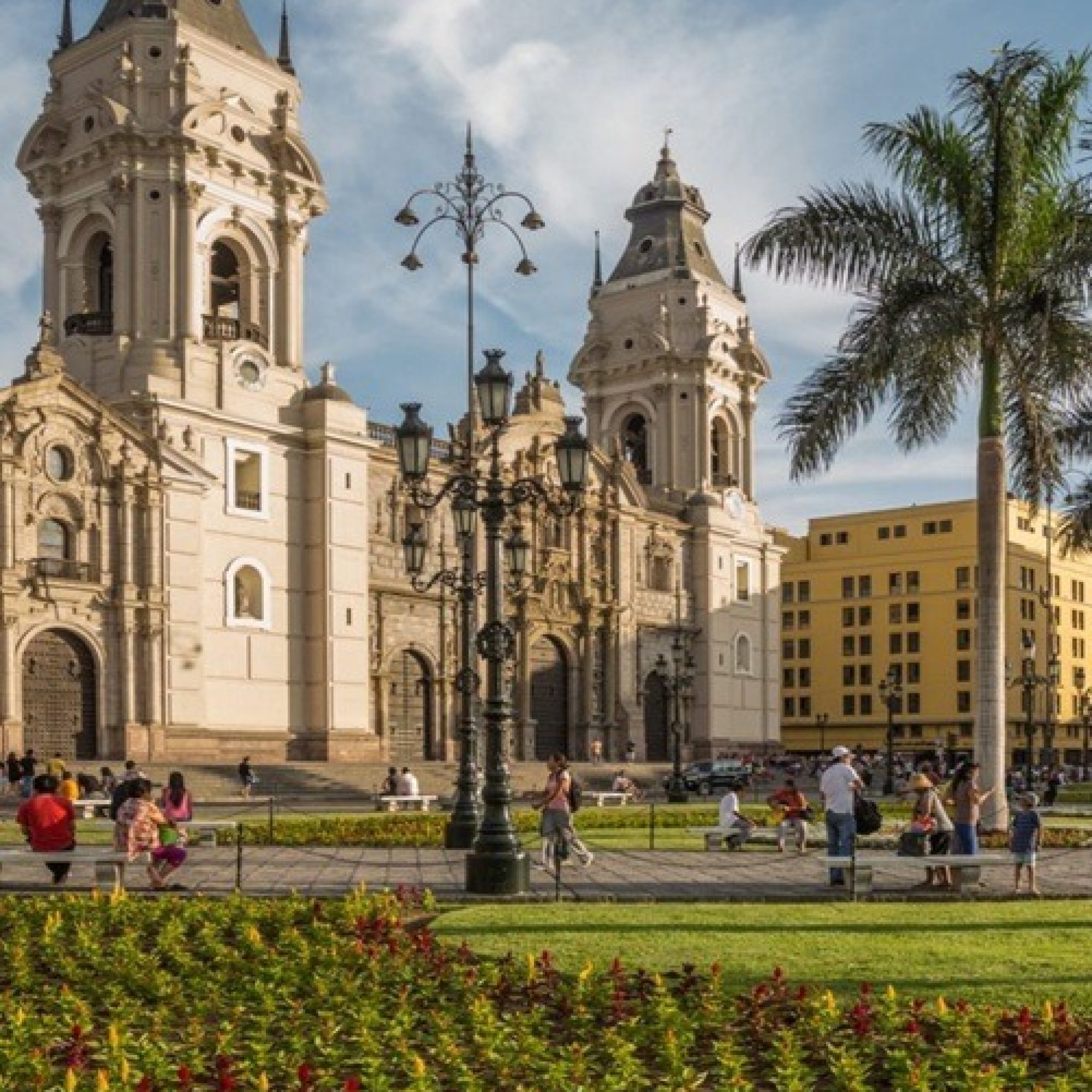 Green gardens and palm trees line the historic…